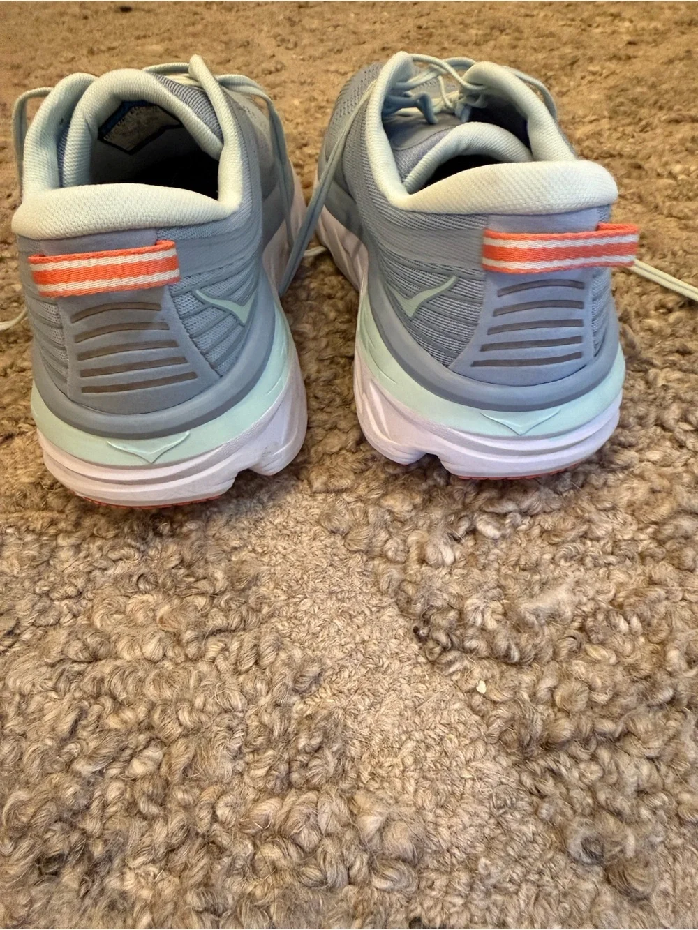 Hoka Pale Gray Running Shoes with orange Accents